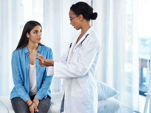 Doctor using her hands to explain something to her patient
