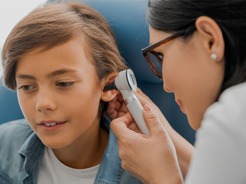 Doctor looking into a child's ear